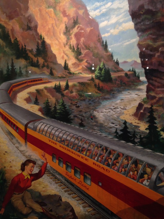 Girl and passing train, Milwaukee Road exhibit, Grohmann Museum, 2015