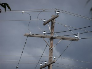 porcelain insulators against dark clouds