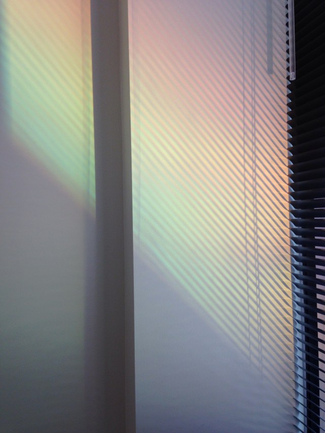 rainbow spectrum of light through Venetian blind