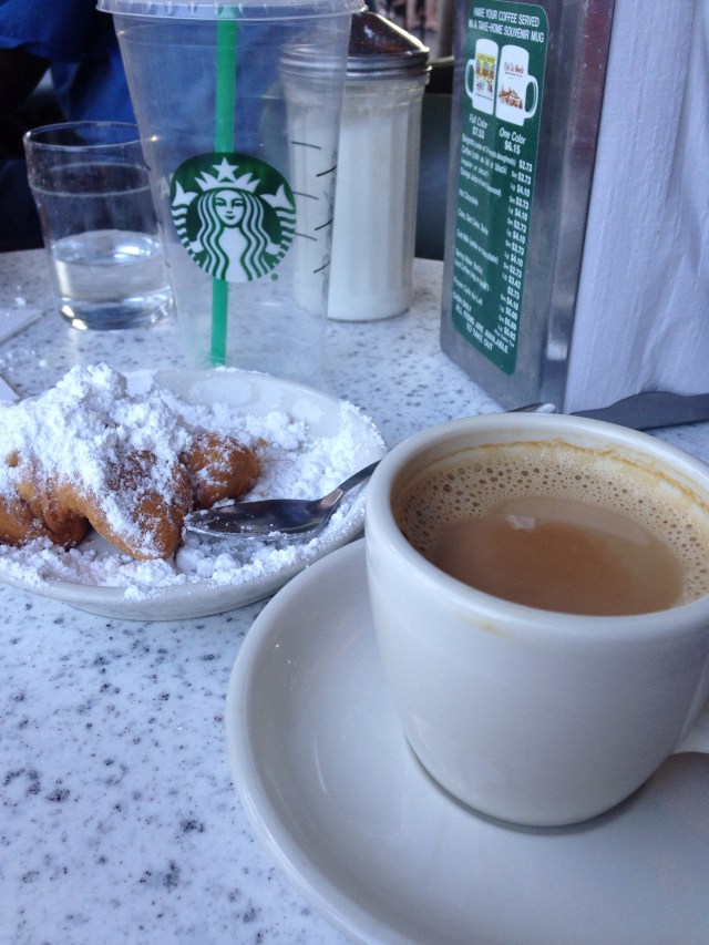 We were so hot that we stopped at Starbucks for cold drinks to sustain us on the walk up to the French Quarter, where we then ordered hot coffee. Hence Cindy's empty Starbucks cup on the table.