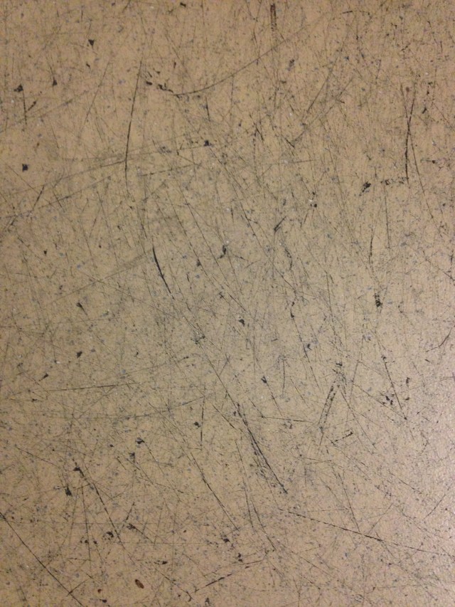 "abstract" photo of floor marked by ice skate blades