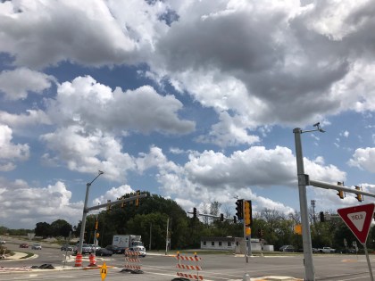 fluffy white clouds in a sunny, blue sky
