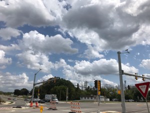 fluffy white clouds in a sunny, blue sky