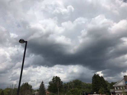 white clouds hanging low in a dark gray sky