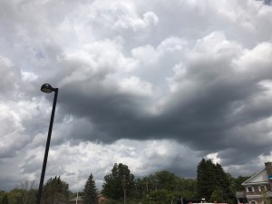 white clouds hanging low in a dark gray sky