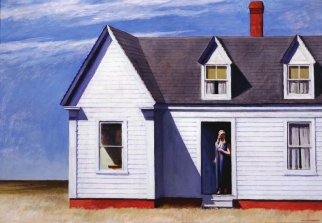 white gabled house with bright noon sunlight and shadow on its walls