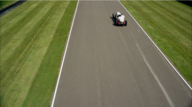 1920s racetrack with decorative stripes mowed into grass along the paved track