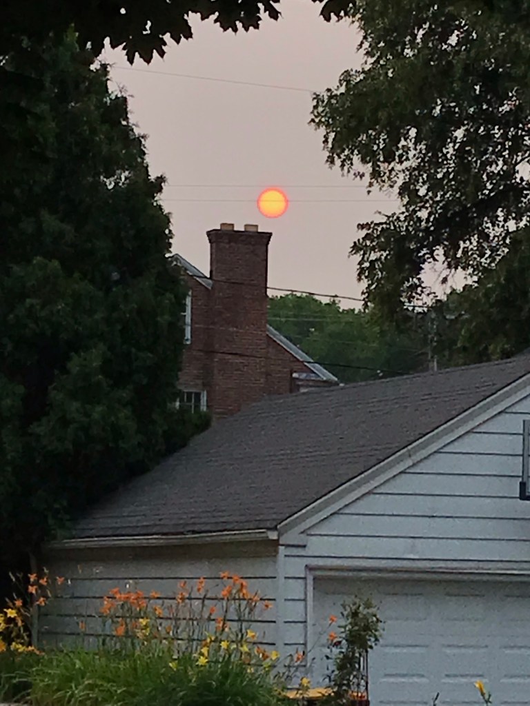 IPhone photo of the sun, strangely orange due to wildfire. Odd yellow center is an iPhone glitch