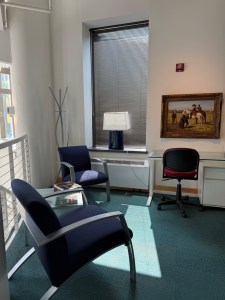 Comfortable chairs in a sunny corner area near the atrium stairs in the Grohmann Museum