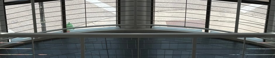 Two windows and an arch of light create a "smiley face" effect on an open staircase.