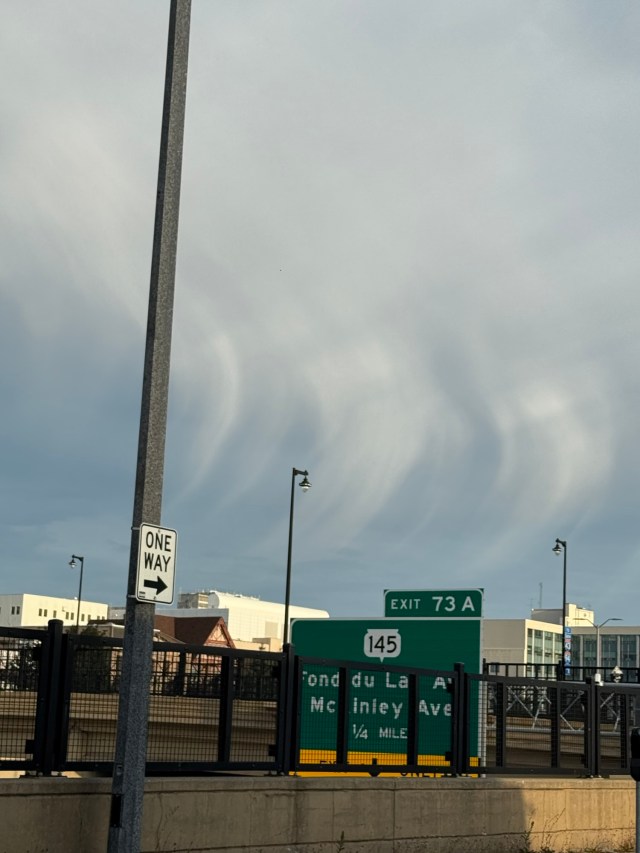 three parallel, comma-shaped cloud wisps