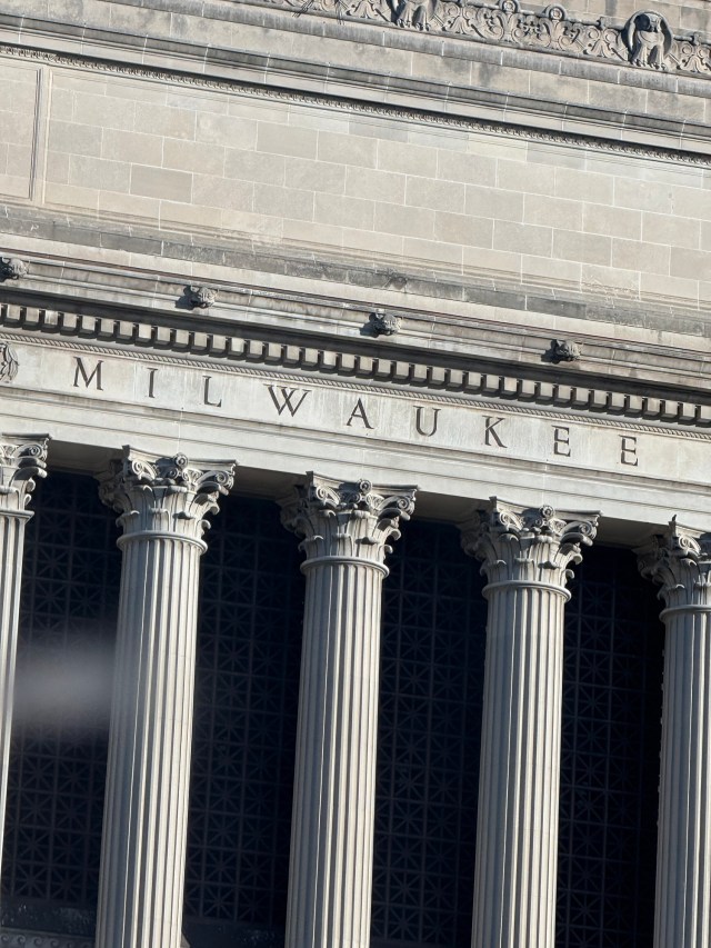 "MILWAUKEE" - photo of the word from the lettering carved into stone atop Corinthian columns at the Milwaukee County Courthouse