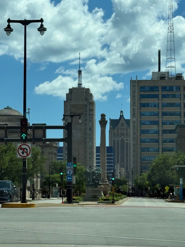 Photo of downtown Milwaukee, taken at street level, showing lots of vertical lines stretching upward