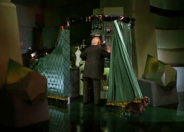Toto pulling back the curtain to reveal the real Wizard of Oz